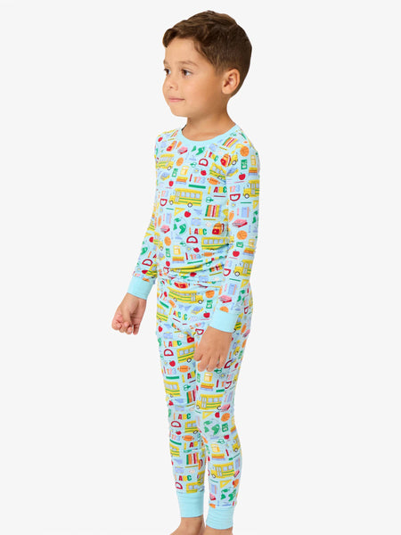 Child wearing colorful pajamas with a pattern on a white background