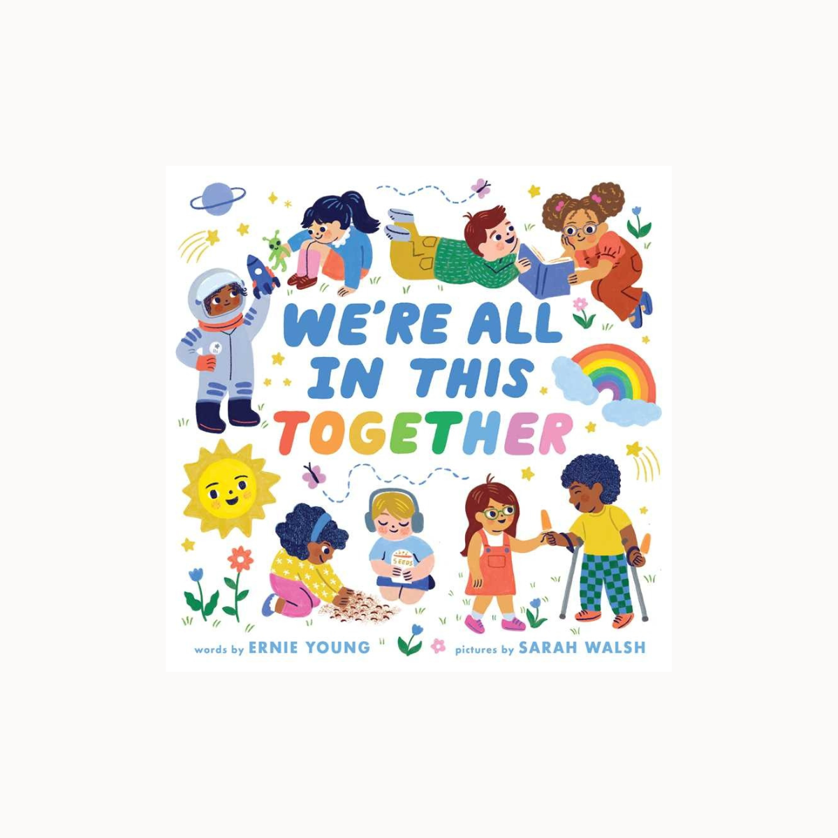 Children's book cover with diverse children and colorful text 'We're All In This Together' by Ernie Young and Sarah Walsh.