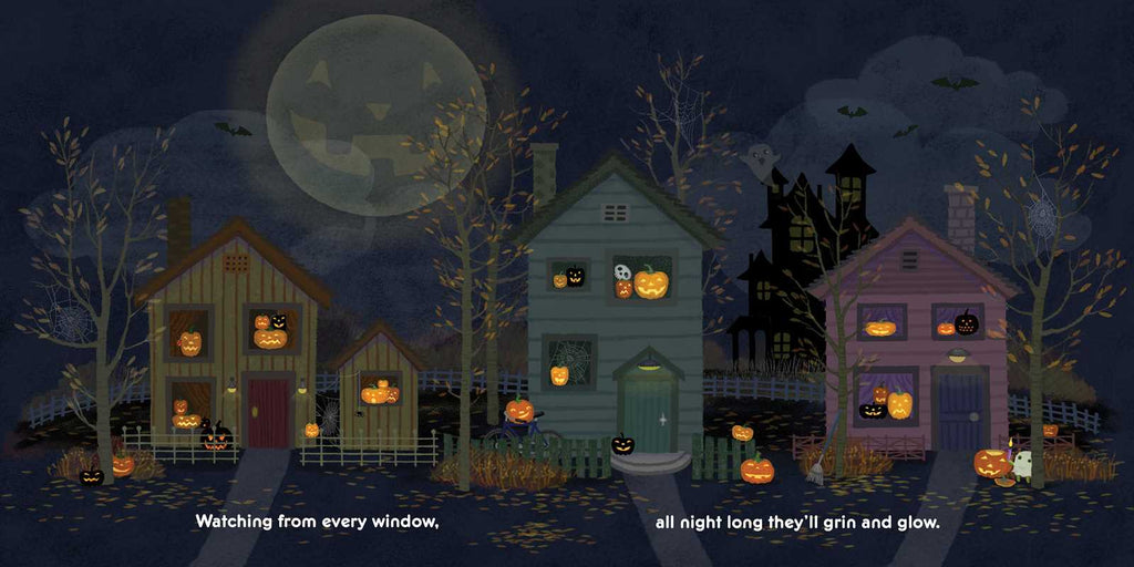 Halloween-themed village with pumpkins and a full moon in the sky.
