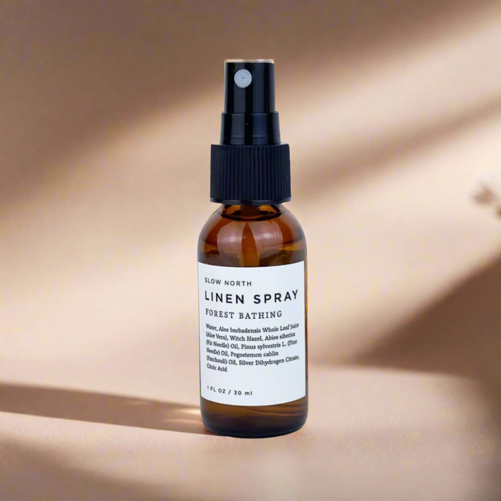 Brown spray bottle labeled 'Linen Spray' on a beige background