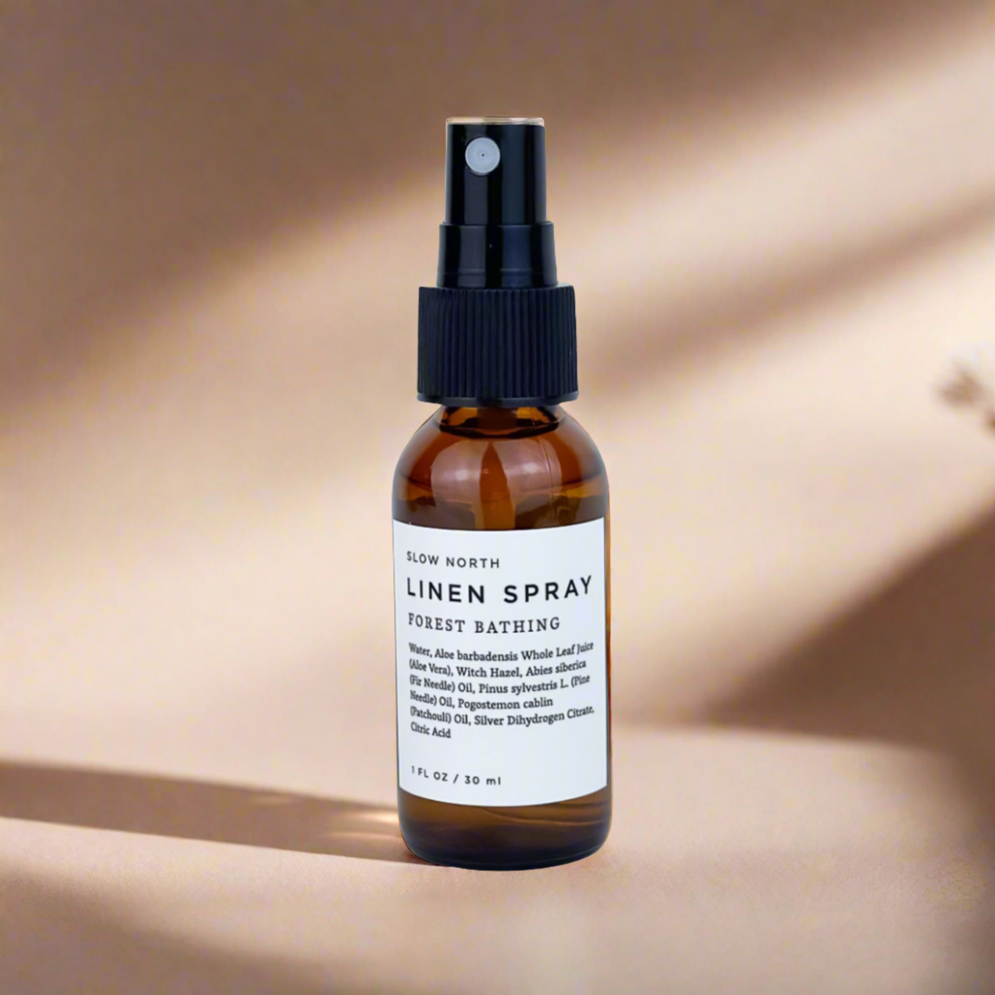 Brown spray bottle labeled 'Linen Spray' on a beige background