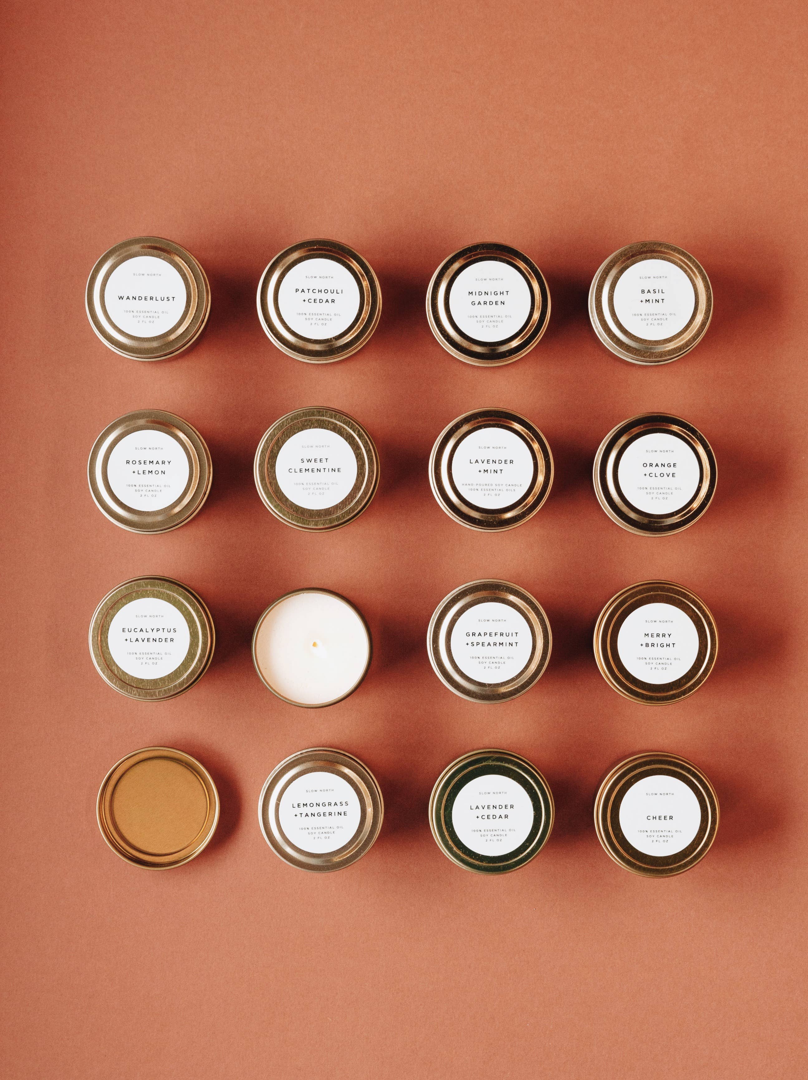 Grid of candles with gold lids on a brown background