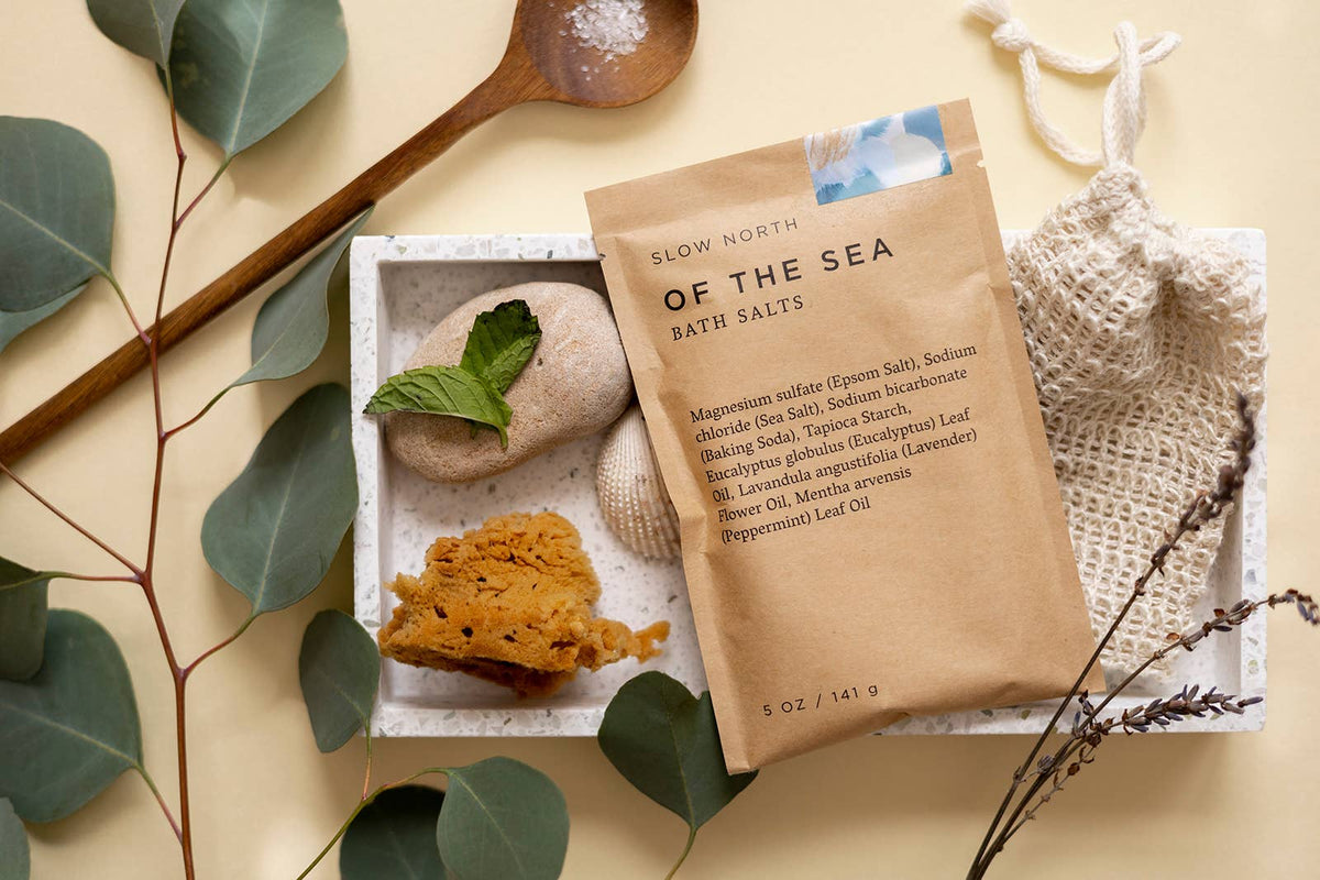 Bath salts packaging with natural elements on a beige background