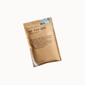 A single brown kraft paper bath salts packet labeled 'SLOW NORTH OF THE SEA BATH SALTS' on a plain white background.