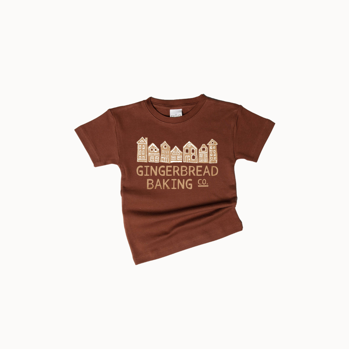 A brown short-sleeve t-shirt with a graphic of gingerbread houses and the text 'GINGERBREAD BAKING CO.' printed in a light tan color, displayed on a clean white background.