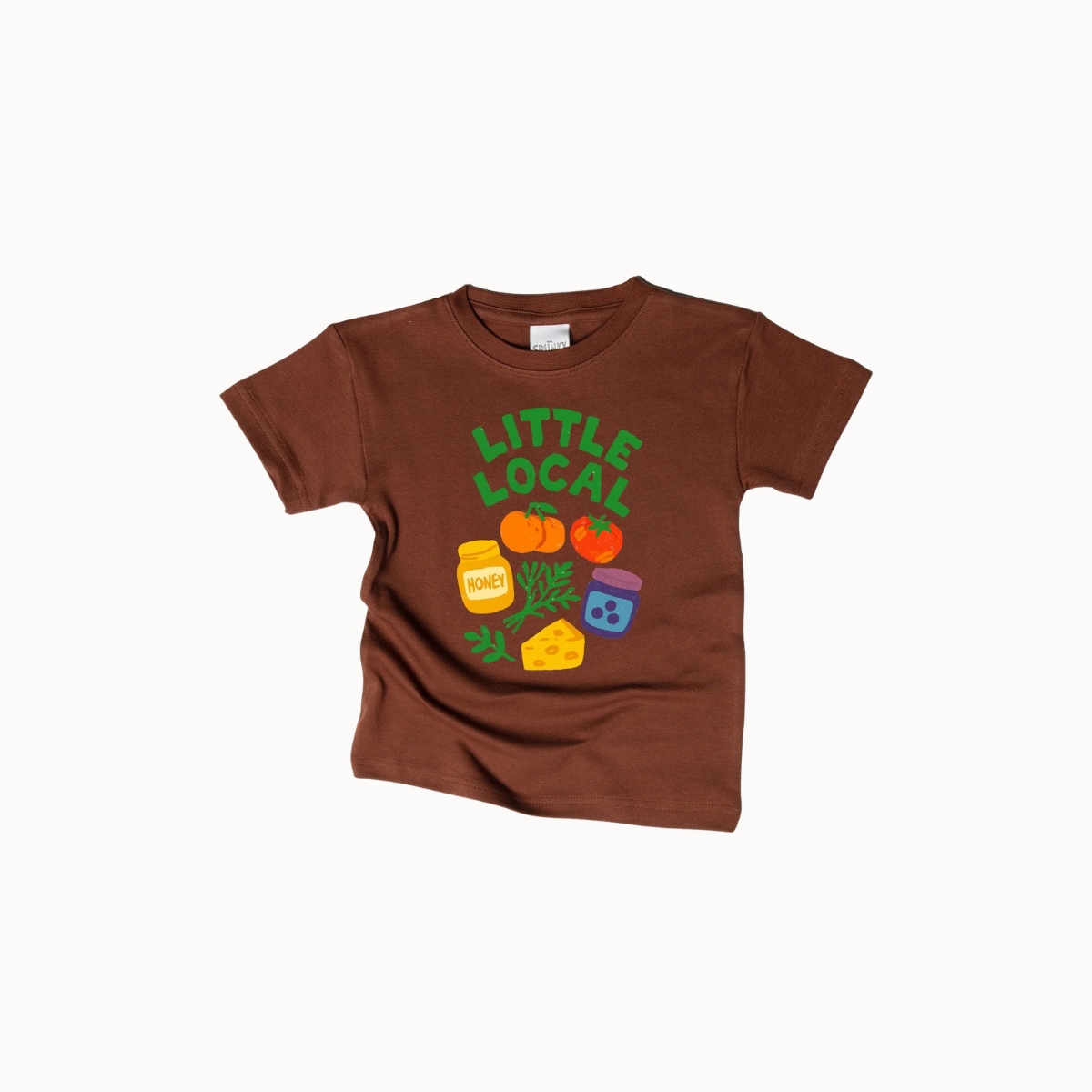 A brown short-sleeve kids' t-shirt with a colorful graphic on the front that reads 'LITTLE LOCAL' above cartoon vegetables, cheese, and a jar, shown on a light gray background.