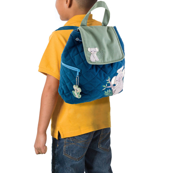 Child wearing a blue backpack with animal designs on a white background
