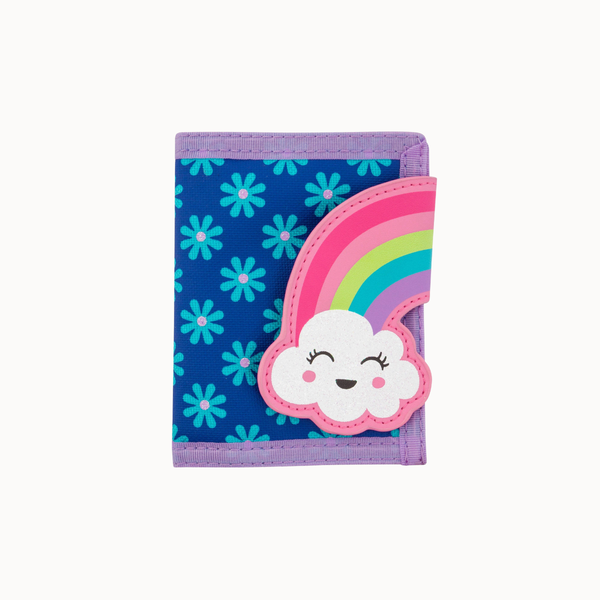 A small bi-fold wallet with a blue background patterned with light blue flowers, featuring a large applique of a smiling white cloud under a pastel rainbow on the front, and purple trim.
