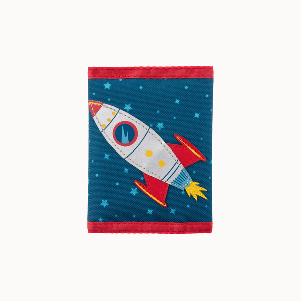 A small fabric wallet or pouch with a blue space-themed print featuring a white rocket ship, red fins and trim, yellow stars, and a blue circular logo, shown on a plain light background.