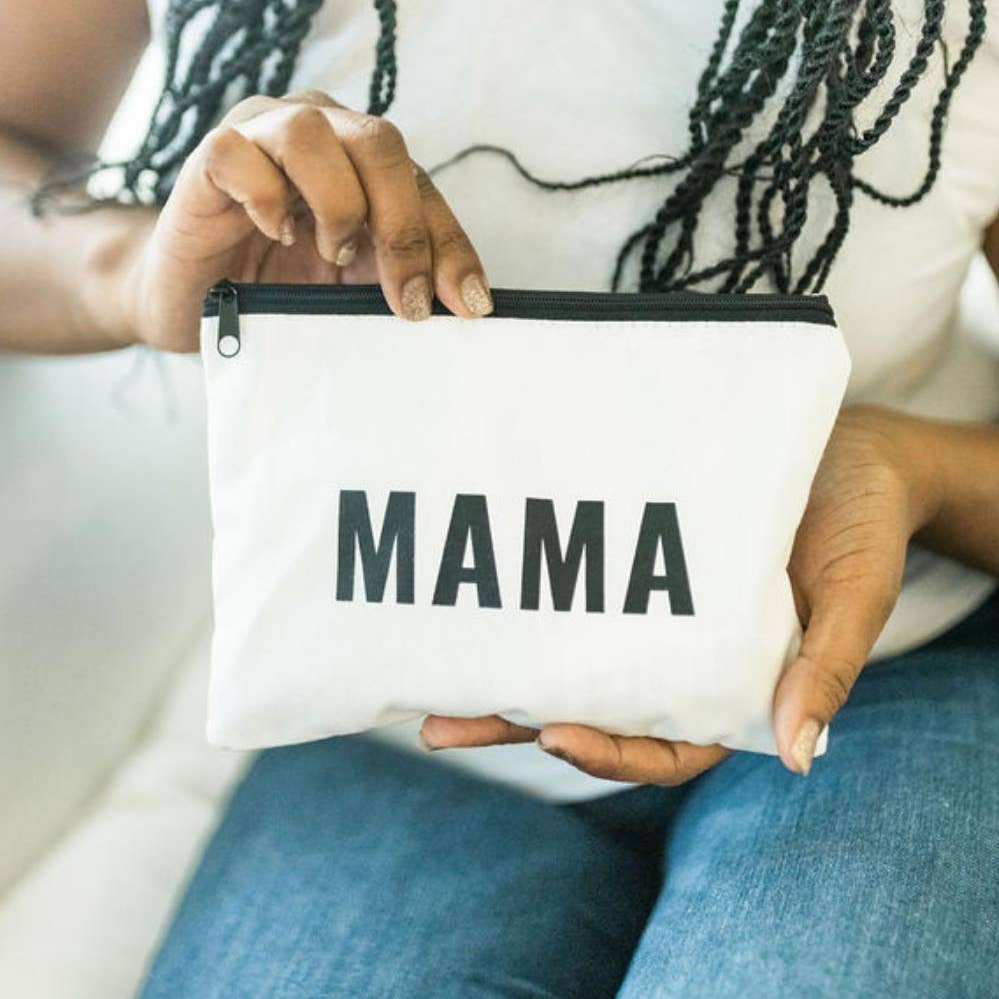Person holding a white pouch with 'MAMA' printed on it.