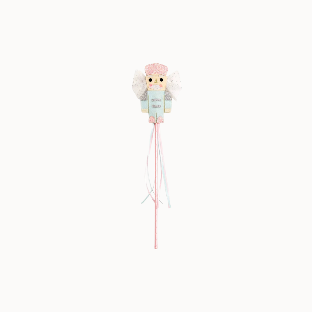 A decorative baby wand or toy featuring a cute angel character with white wings, a pink hat, and a light blue dress, holding long pink and white ribbons on a plain white background.
