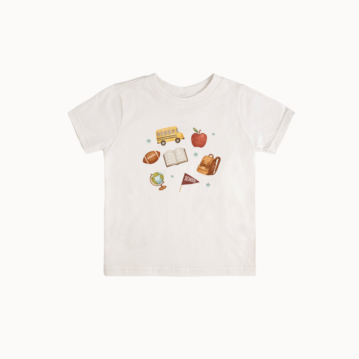 A white short-sleeve baby t-shirt with a colorful school-themed graphic print on the front, featuring illustrations of a yellow school bus, an apple, a football, an open book, a backpack, and a small flag.