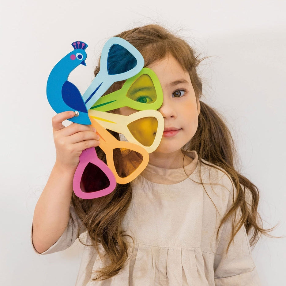 Child holding colorful toy against a white background