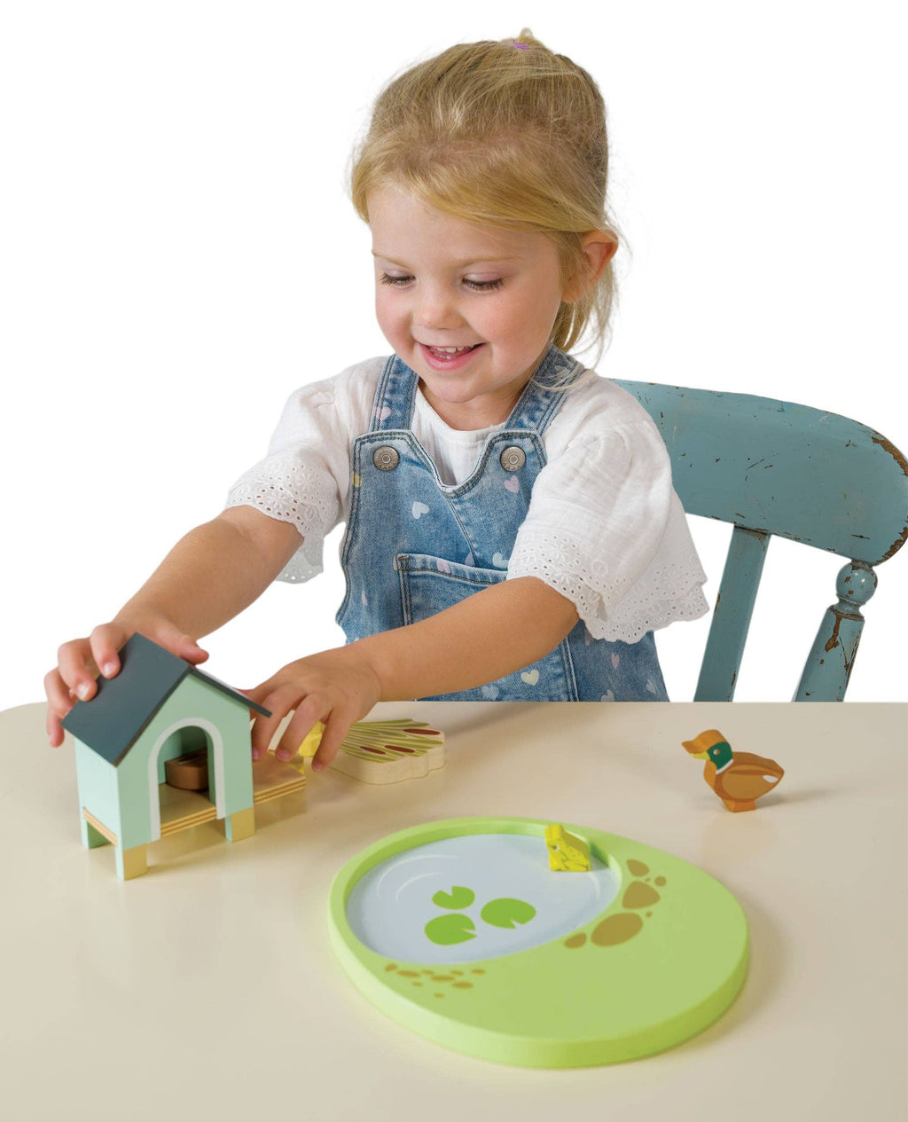 Child playing with wooden toys on a table