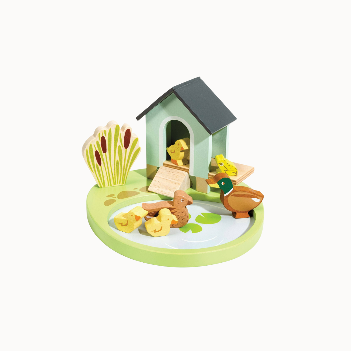 A wooden toy farm scene on a round base, featuring a small house, ducks, chicks, a frog, reeds, and a duckling, photographed on a white background.
