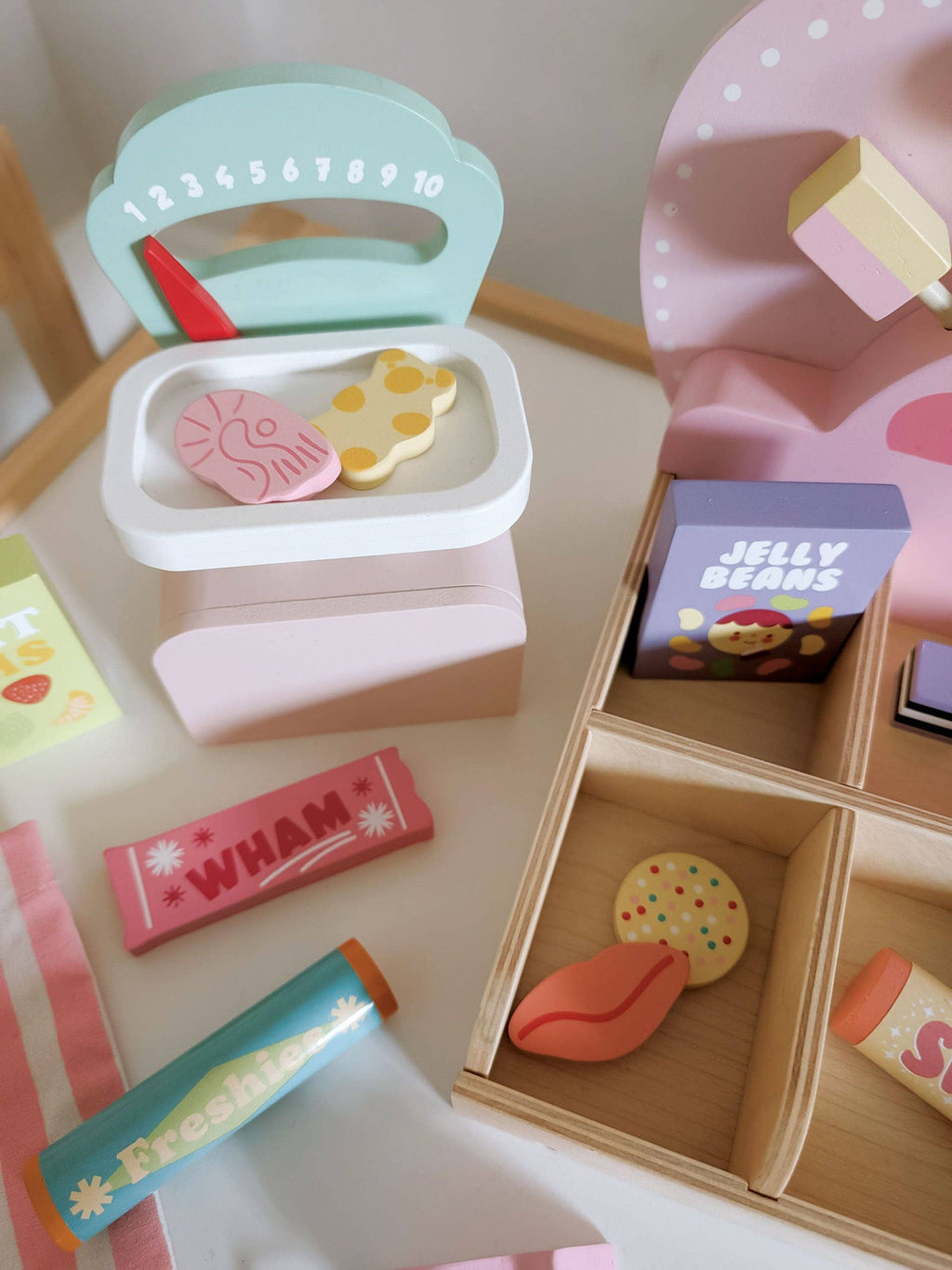 Colorful toy kitchen set with various items on a wooden surface