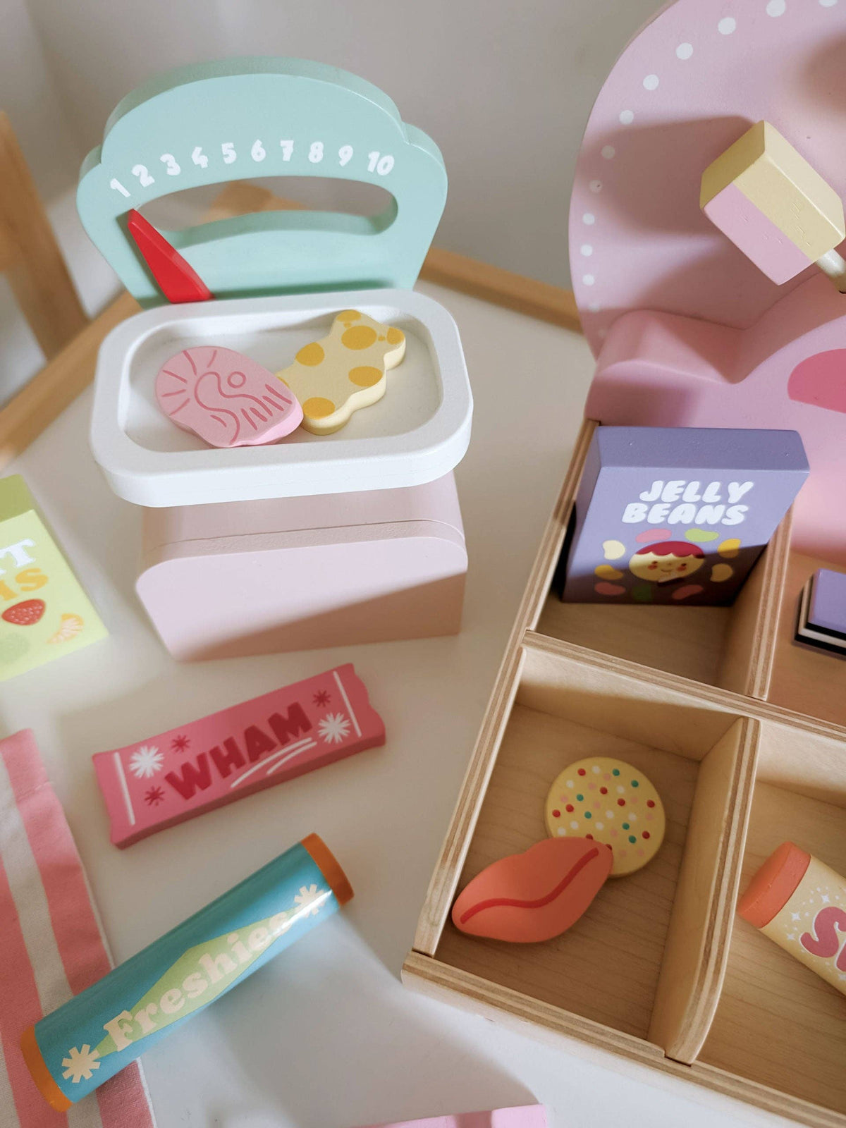 Colorful toy kitchen set with various items on a wooden surface