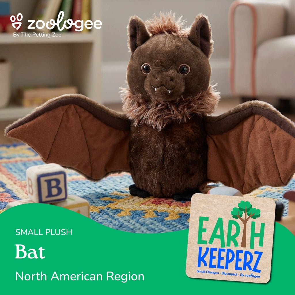 A small plush bat toy with spread wings sits on a colorful rug in a home setting. The image includes the Zoologee brand logo at top left and a product label at bottom right reading 'Earth Keeperz Small Plush Bat North American Region.