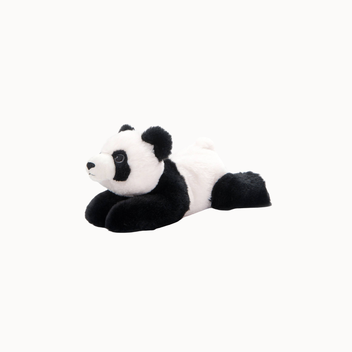A black and white plush panda toy lying on its side against a solid off-white background.