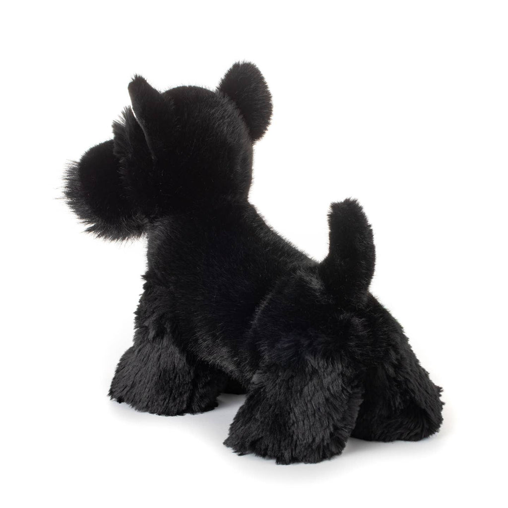 Black plush toy dog on a white background