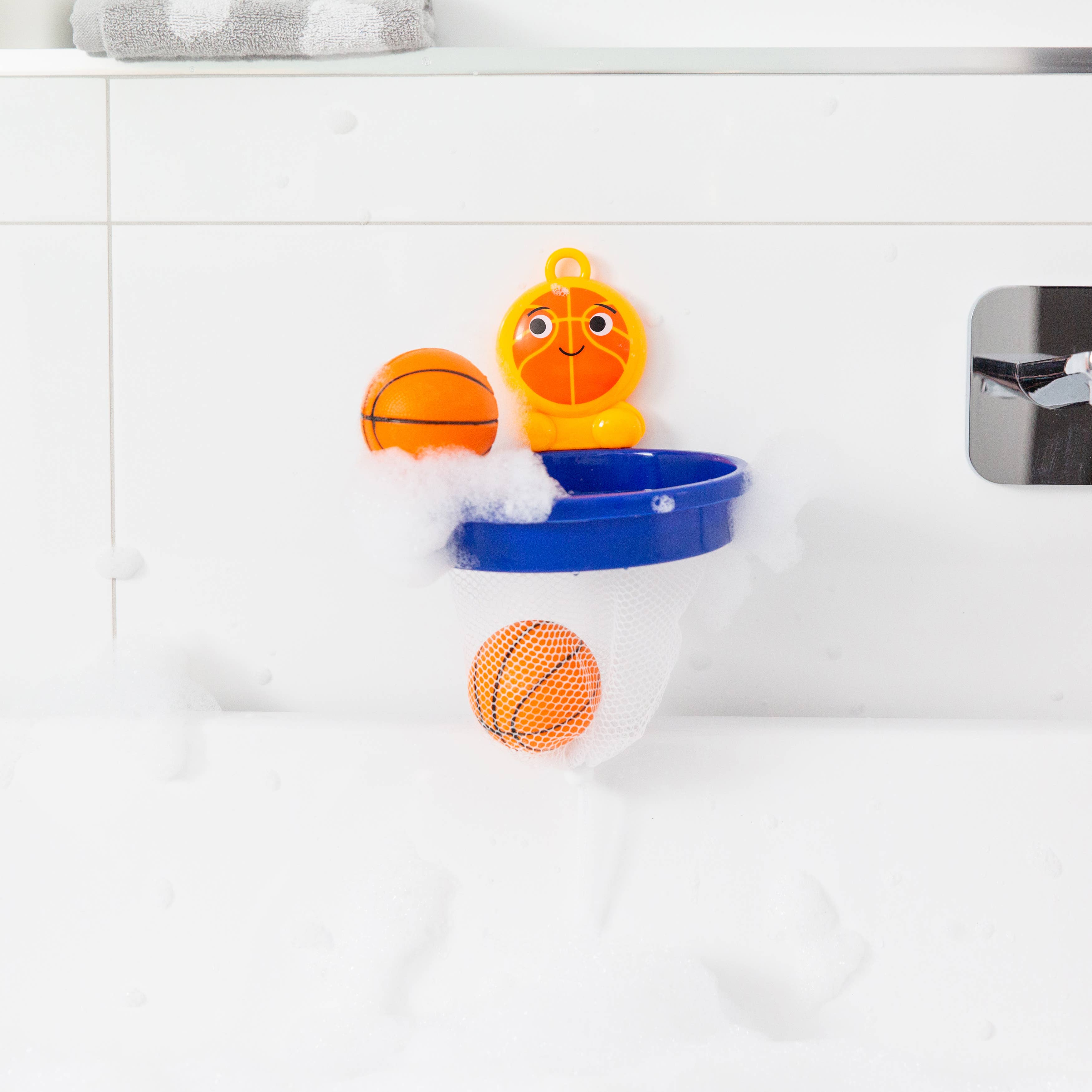 Bath toy with basketballs and a hoop in a bathtub filled with water.