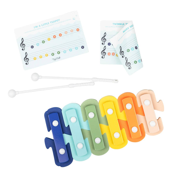 Set of colorful xylophone keys with music notation cards on a white background