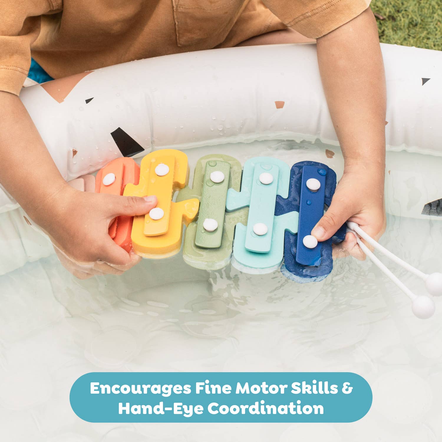 Child playing with colorful letter-shaped toys in water, with text 'Encourages Fine Motor Skills & Hand-Eye Coordination'.