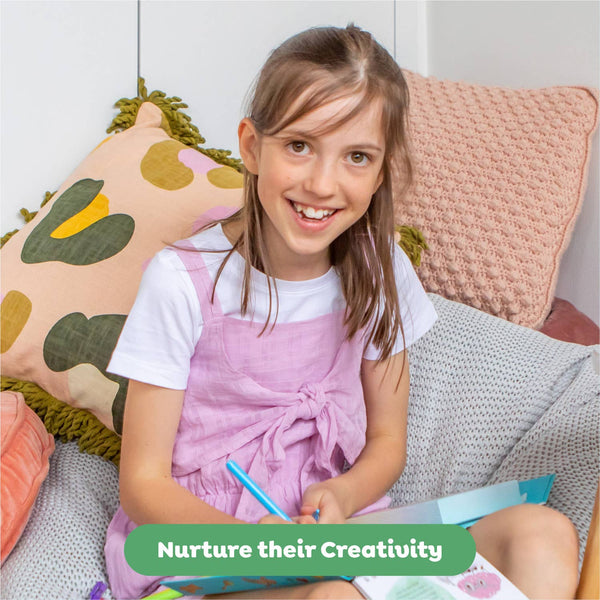 Young girl sitting on a couch with colorful pillows, holding a pen and paper, with a text overlay 'Nurture their Creativity'.