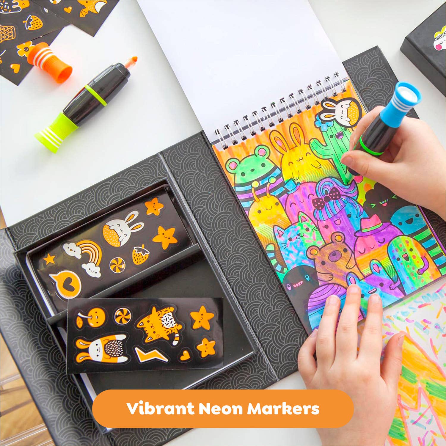 Coloring book with vibrant neon markers and a hand coloring pages.