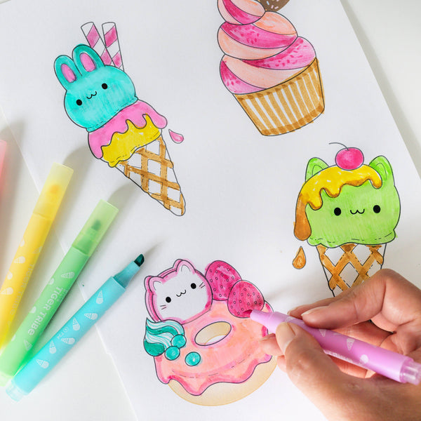 Coloring book with ice cream cone, cupcake, and donut designs, with markers on a white background.