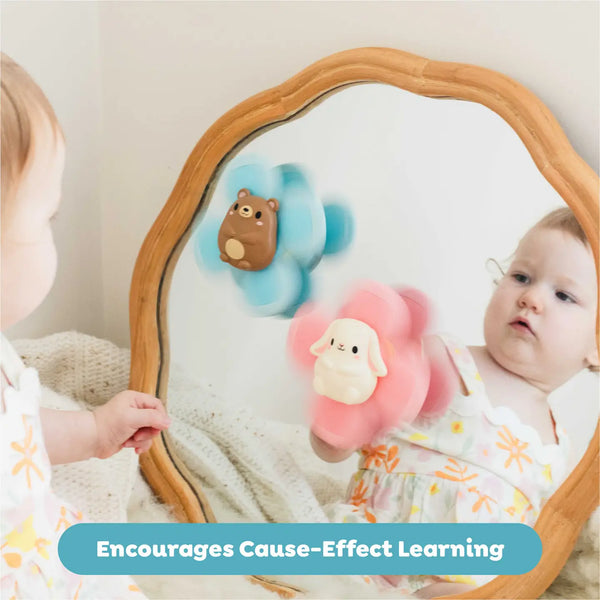 Baby looking in a mirror with the sensory spinners on it. 