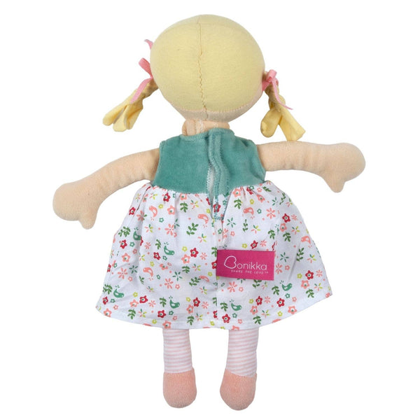 Toy doll with a floral dress and green top on a white background
