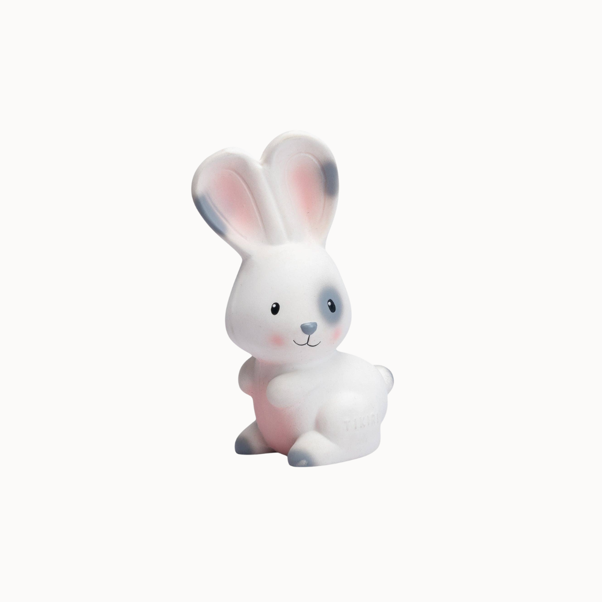 A small white bunny figurine with pink inner ears, a blue-gray right eye and nose, and small gray feet, shown on a plain light background.