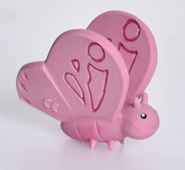 Pink butterfly-shaped object with a visible CE mark on a white background