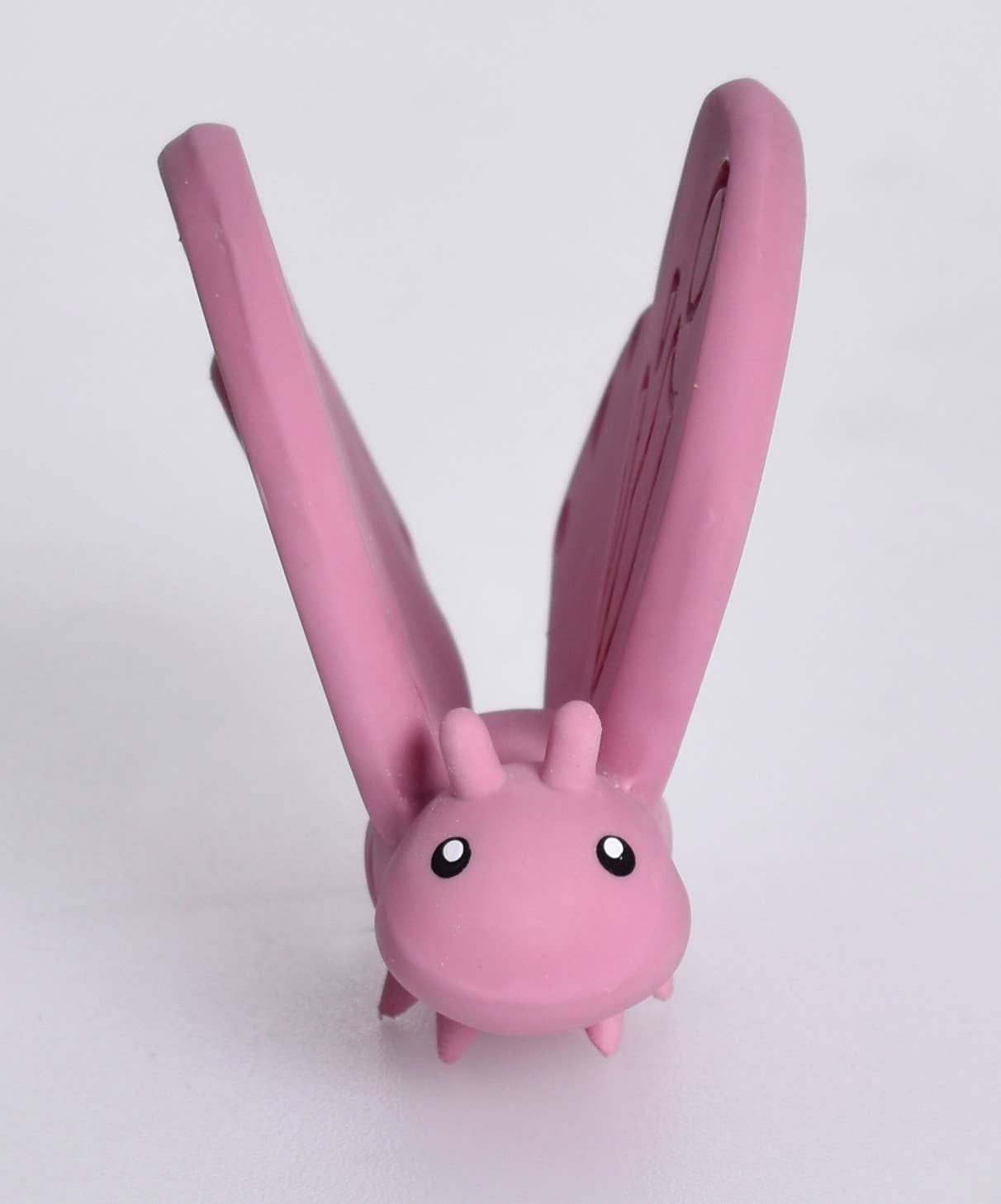 Pink hair straightener with cartoon face on a white background