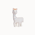 A white llama toy figurine with a small orange patch on its forehead, blue eyes, and a colorful string-light style collar, shown against a plain off-white background.