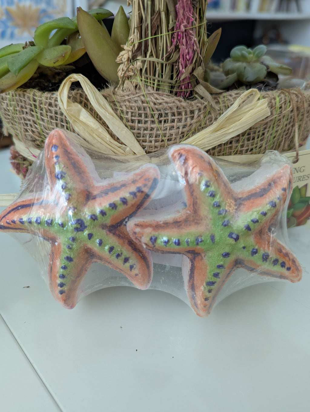 Colorful starfish-shaped object with decorative elements on a white surface.
