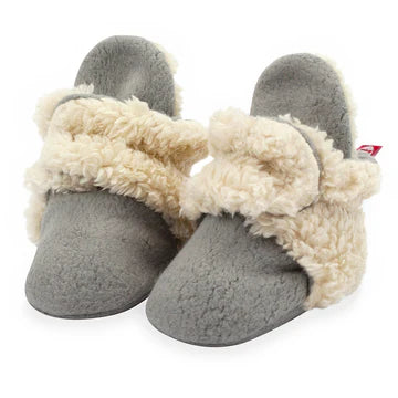 Gray slippers with white fur trim on a white background