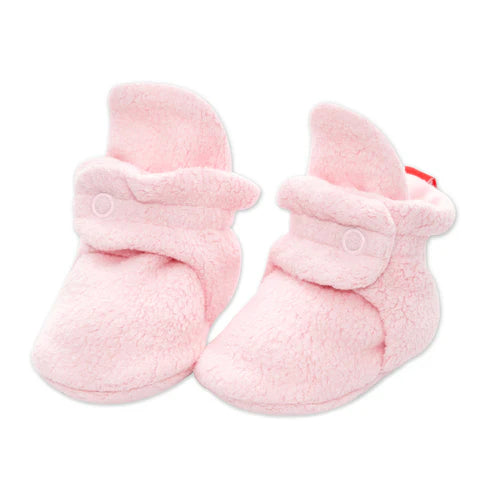 Pair of pink baby booties on a white background