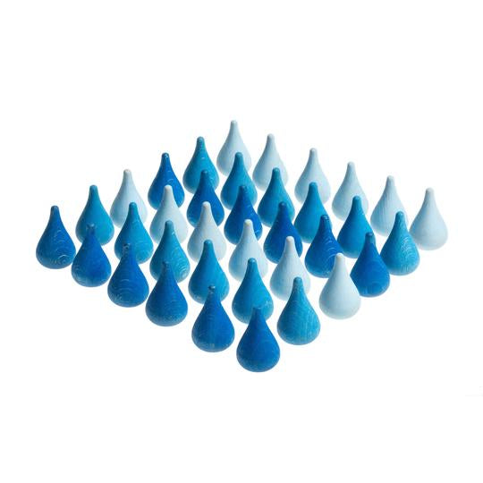 A collection of blue wooden raindrop-shaped pieces arranged in a pattern.