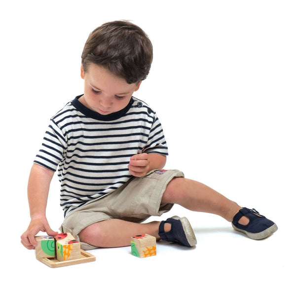 Child playing with wooden blocks on a white background