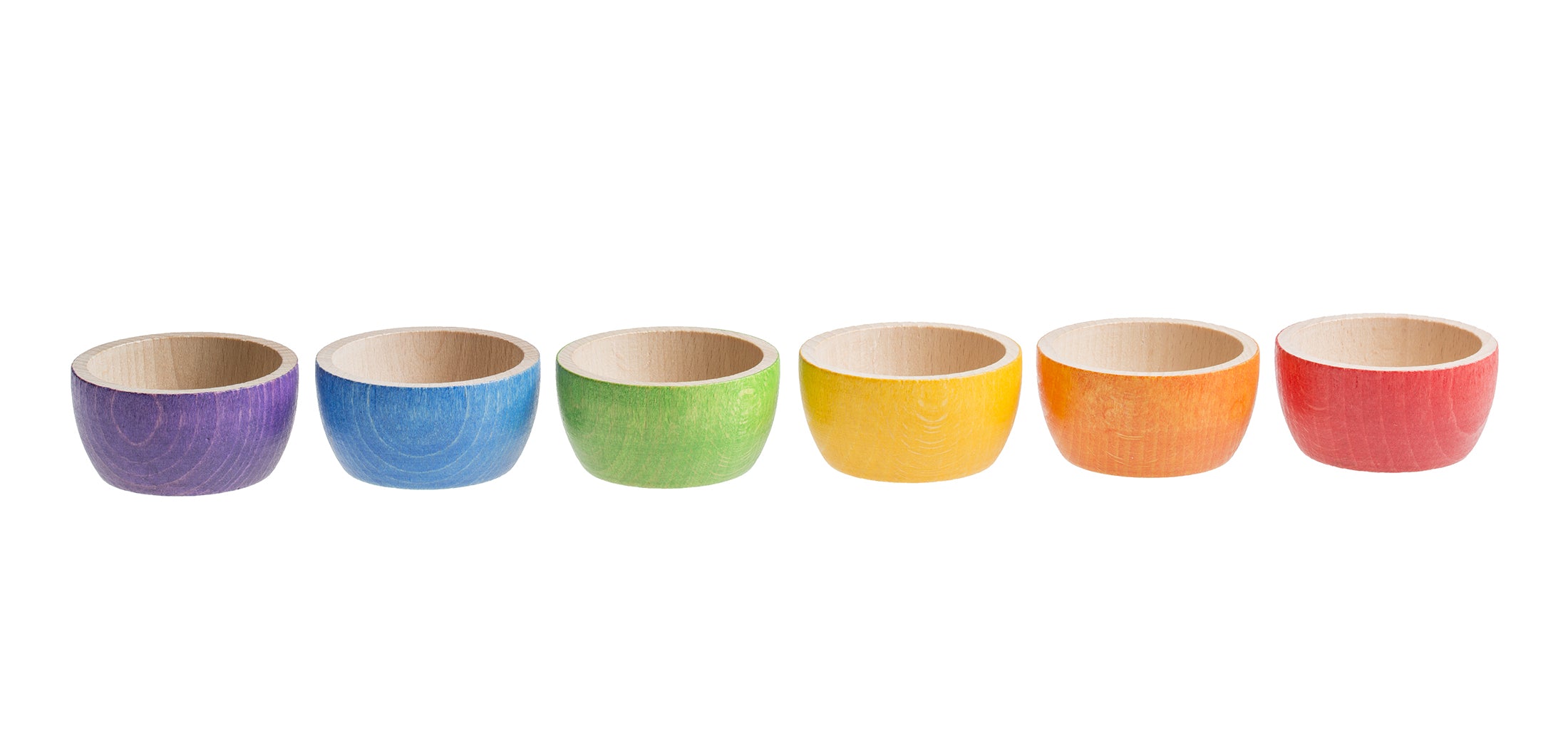 A set of six wooden bowls in a rainbow color palette, displayed in a row.